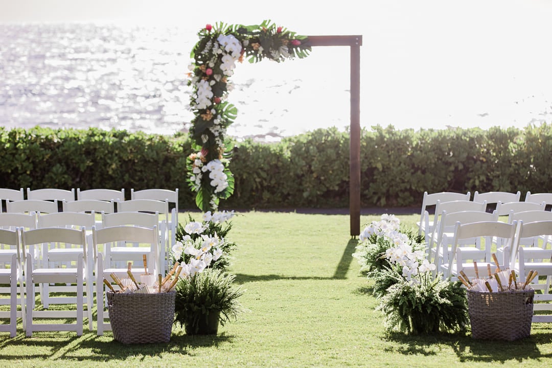 archway with flowers and ocean in the background