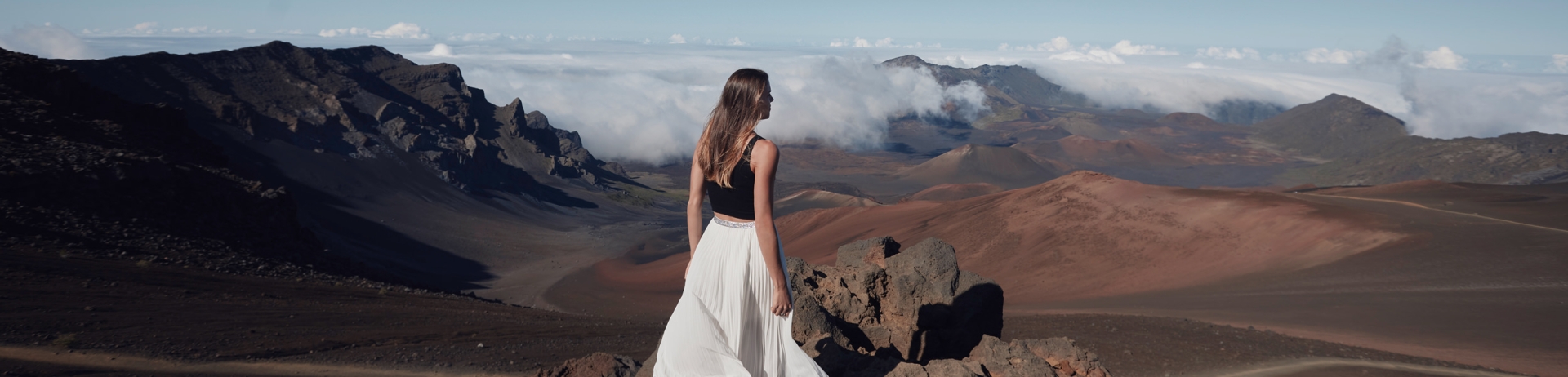 well dressed woman walking on rocks