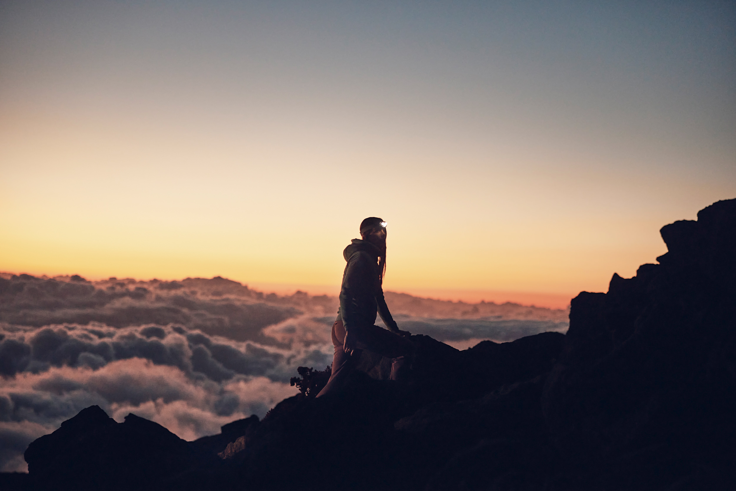 two hikers wearing headlamps