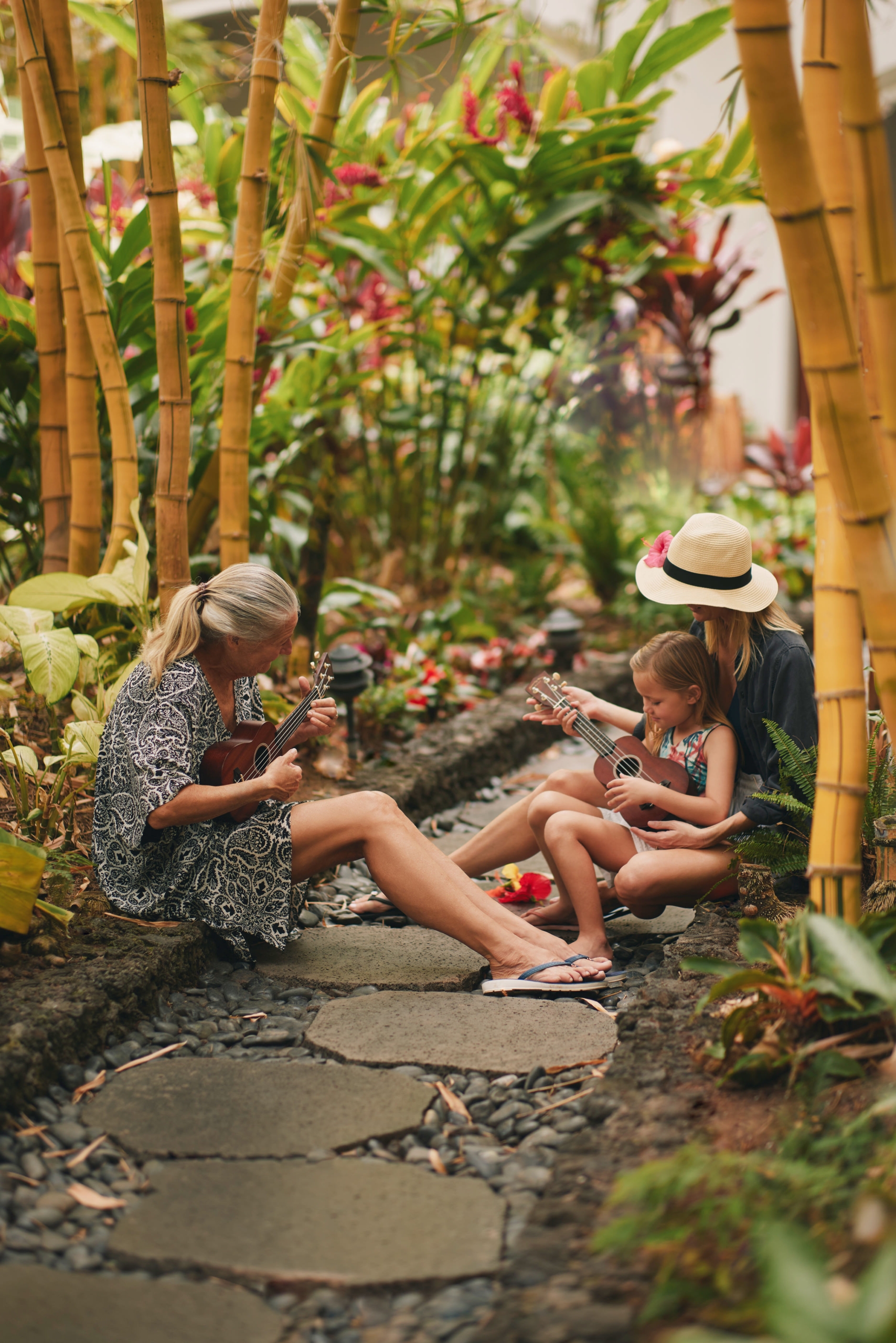 family learning how to play the ukulele