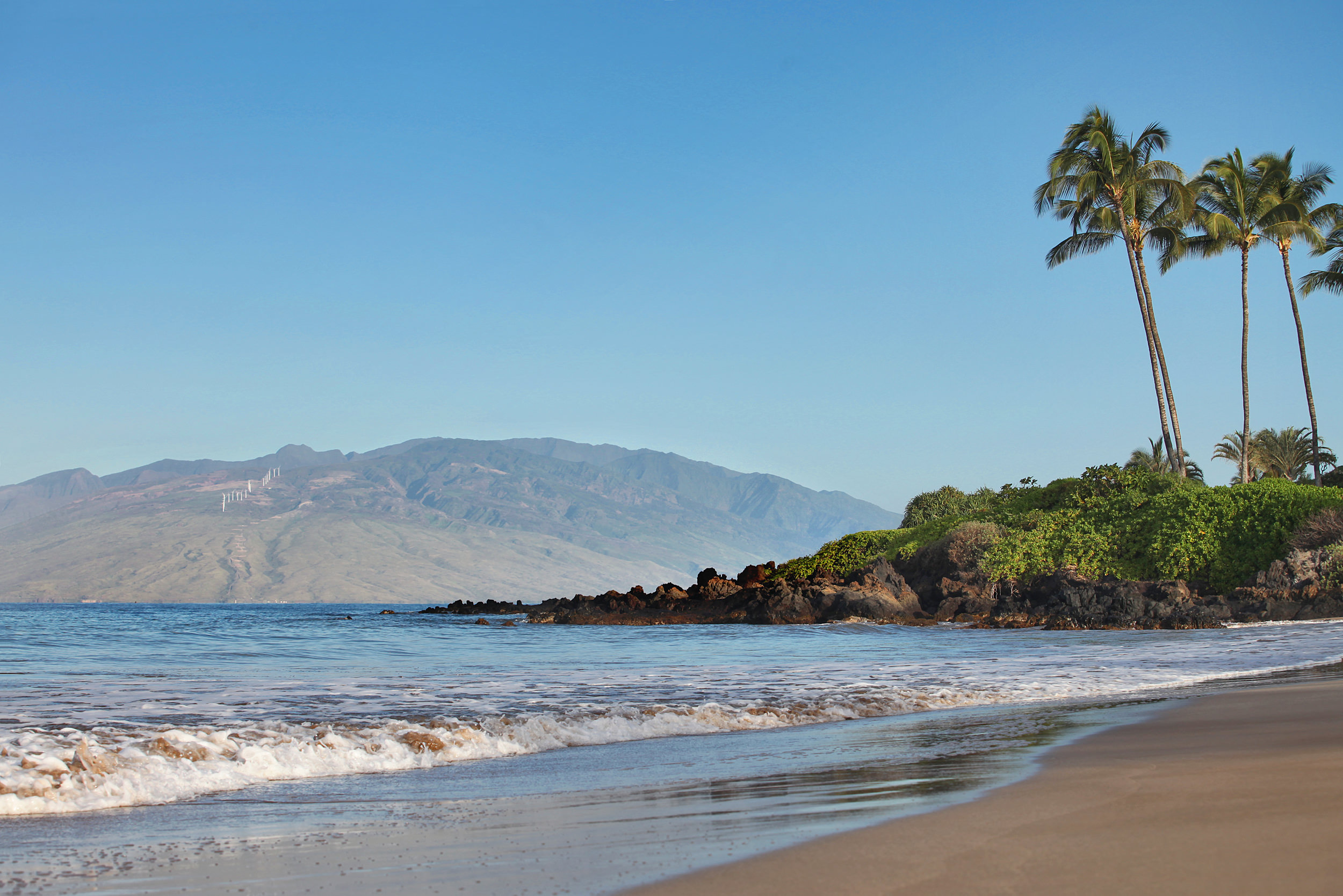 view of a mountain from the beach
