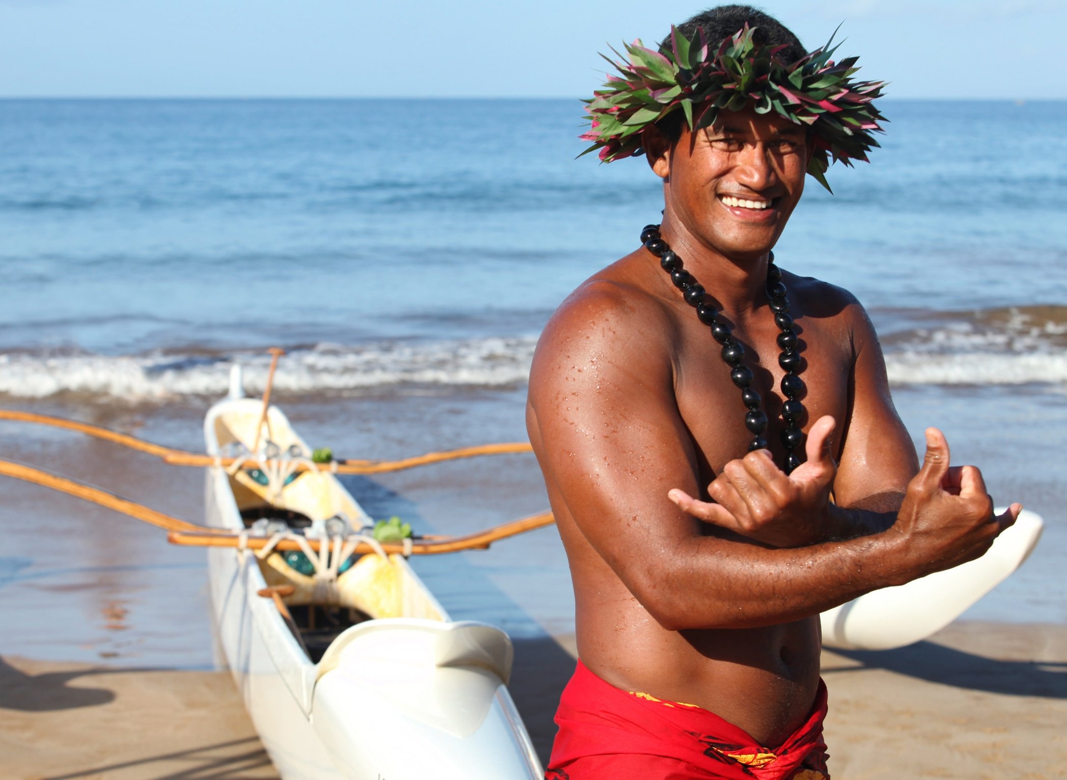 a man standing in front of a canoe