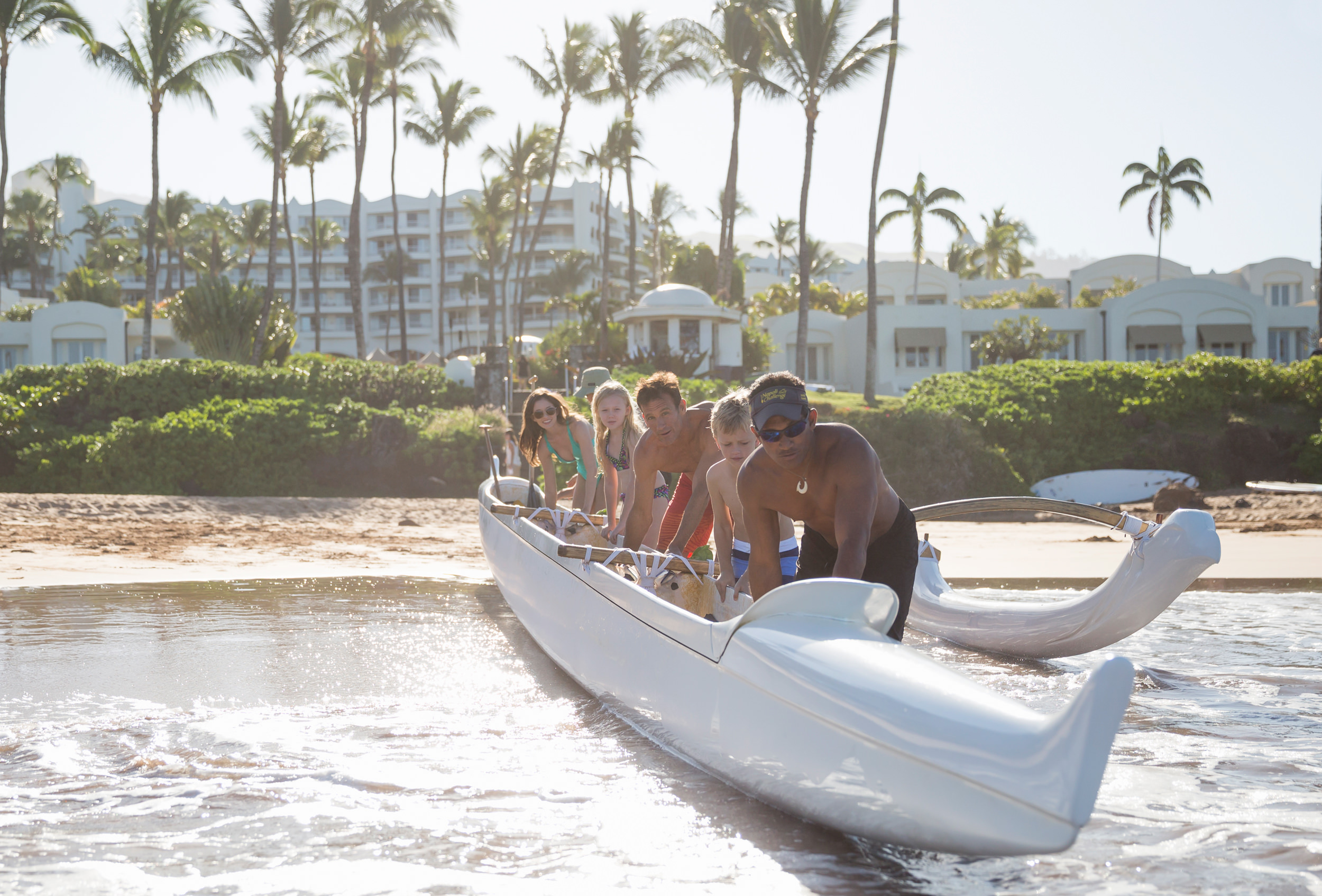 a family canoeing with an instructor