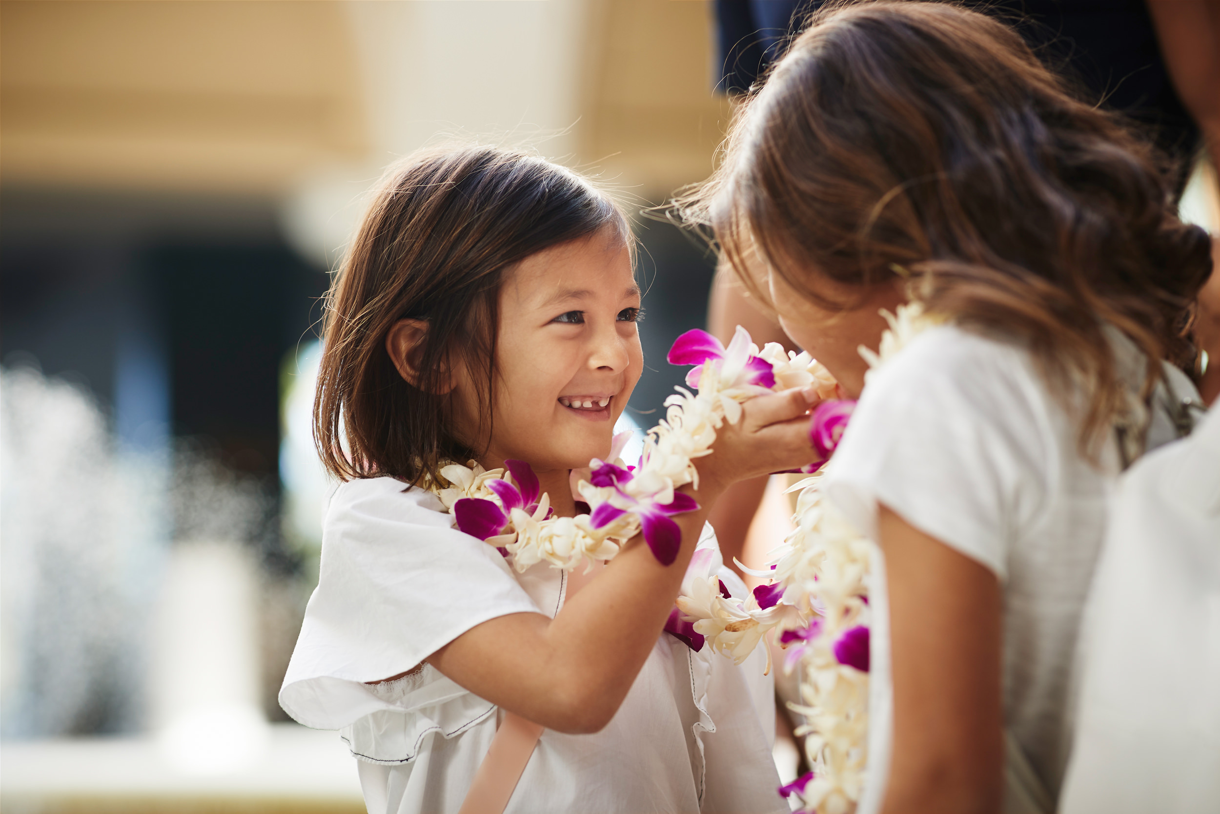a girl showing her mother her lei