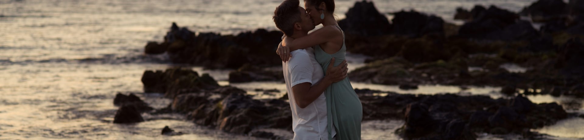 a couple kissing on the beach