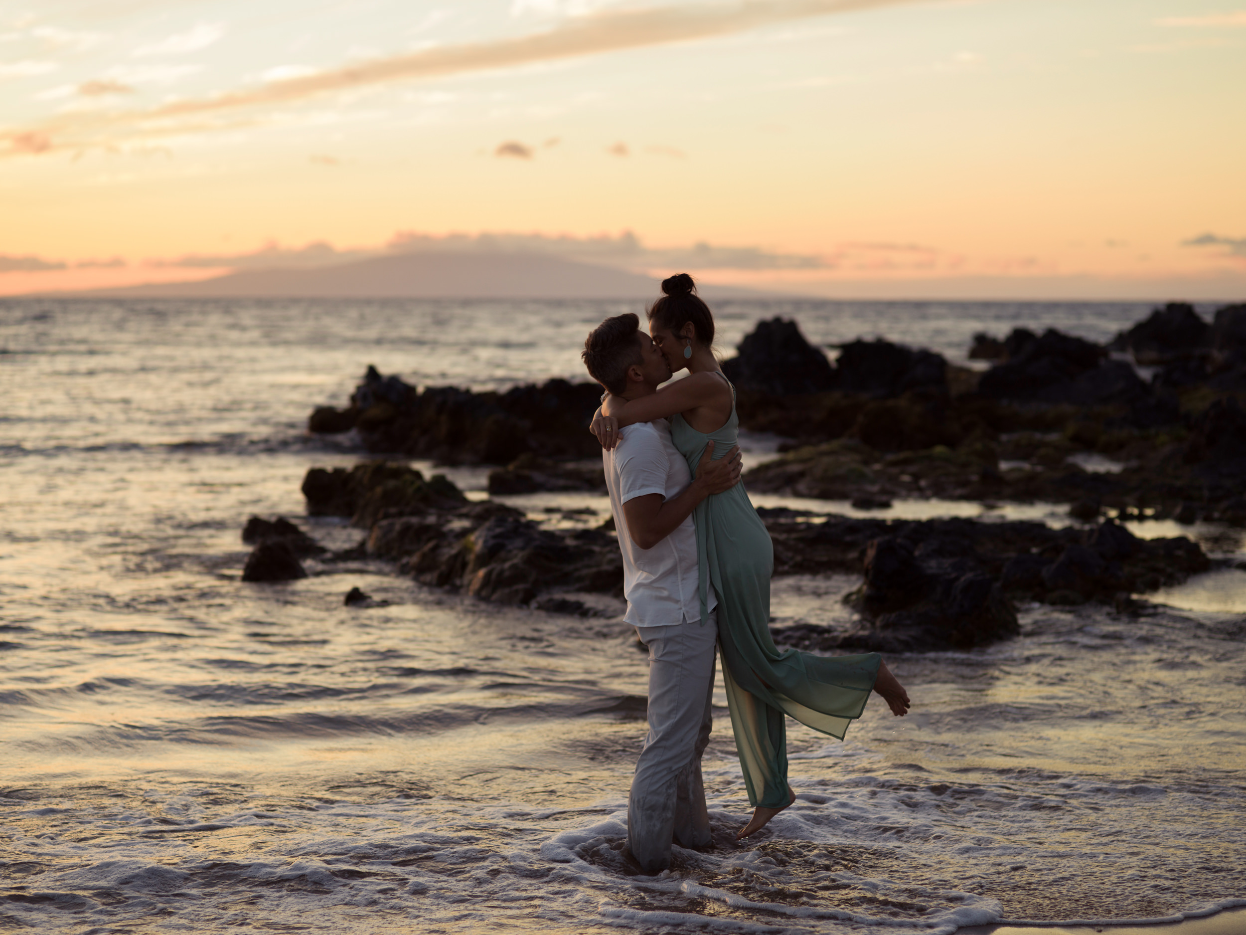 a couple kissing on the beach