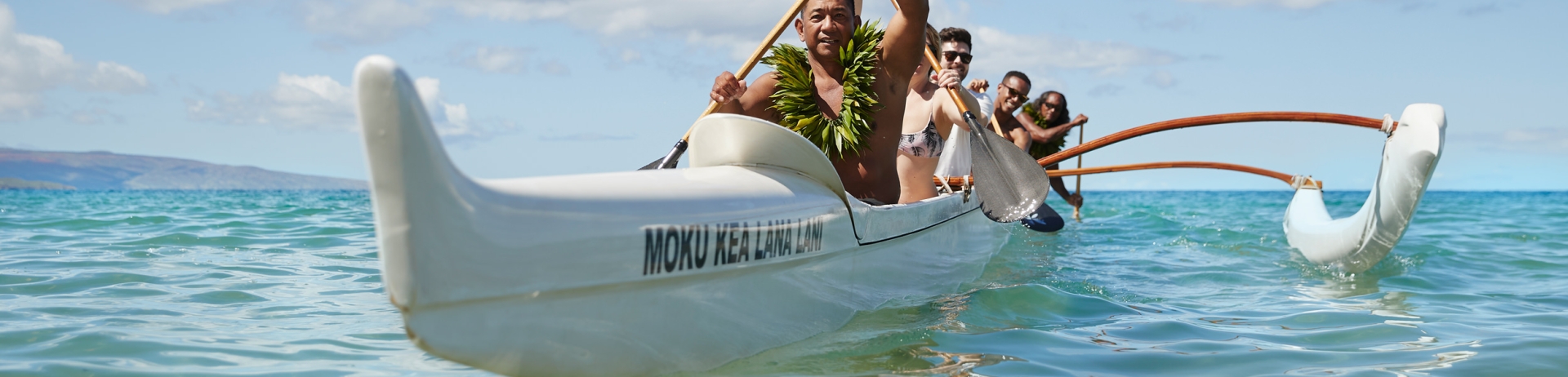 people in an outrigger canoe