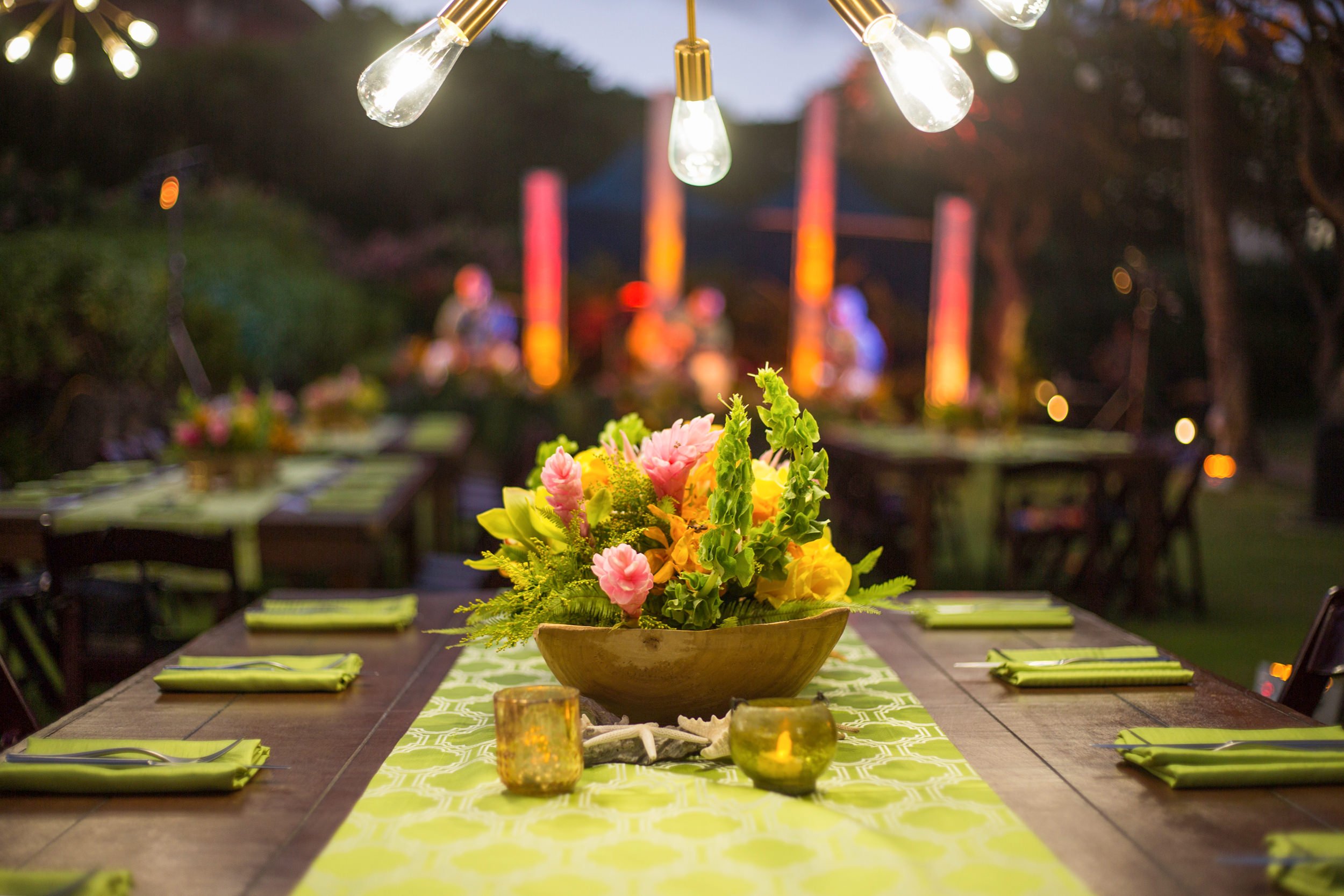 table set up with floral center piece and hints of green