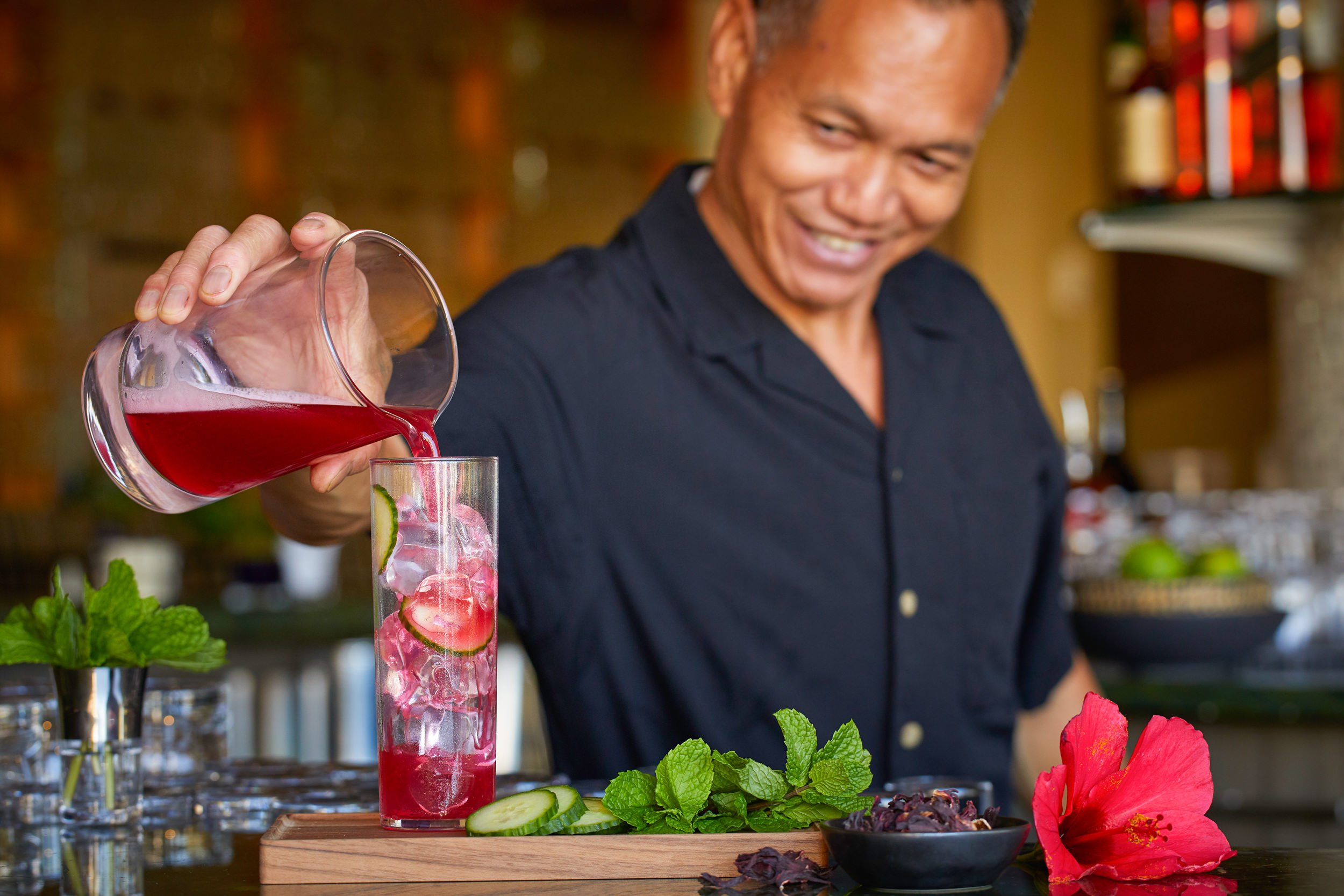 Bartender pouring red cocktail