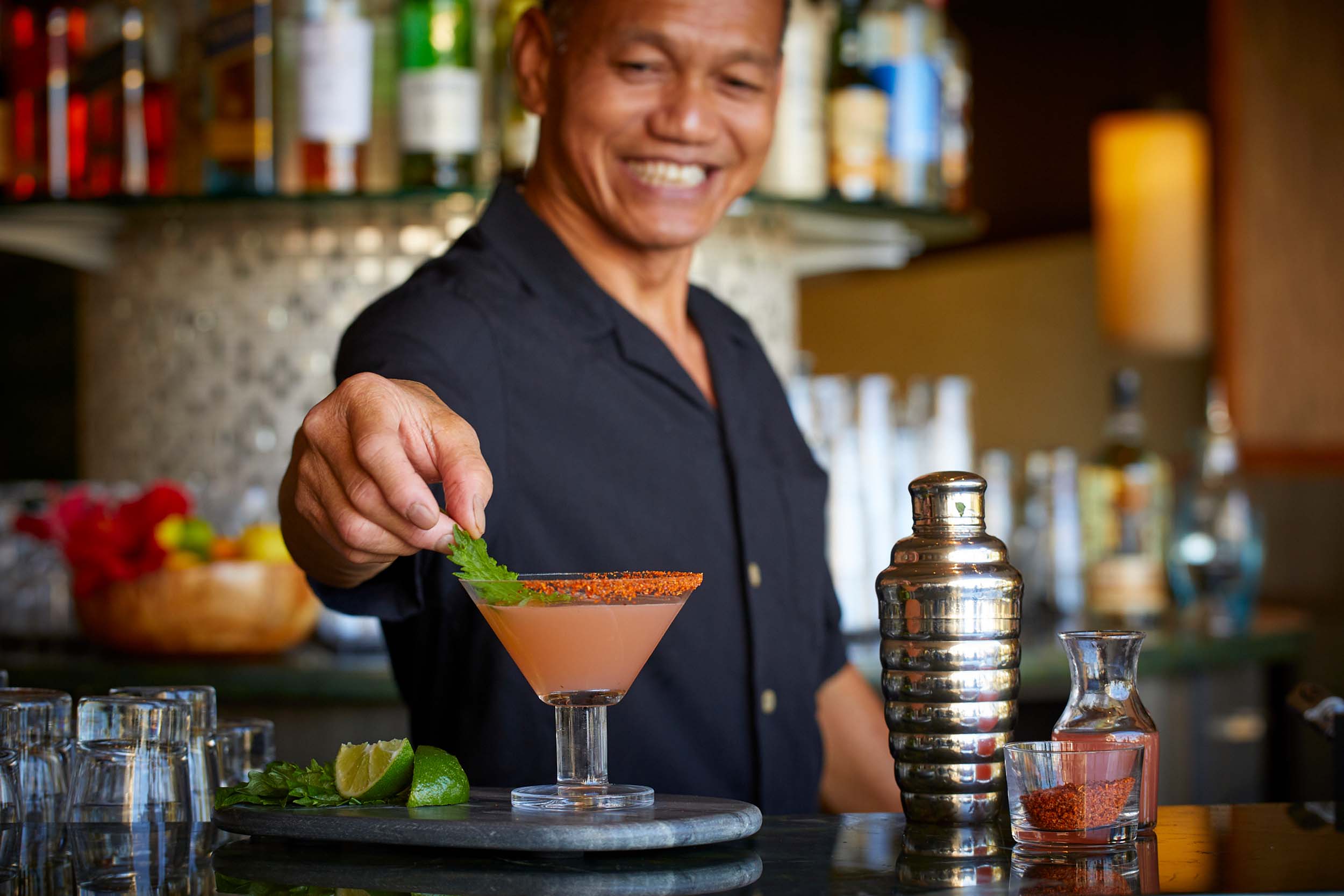 bartender adding garnish to a drink