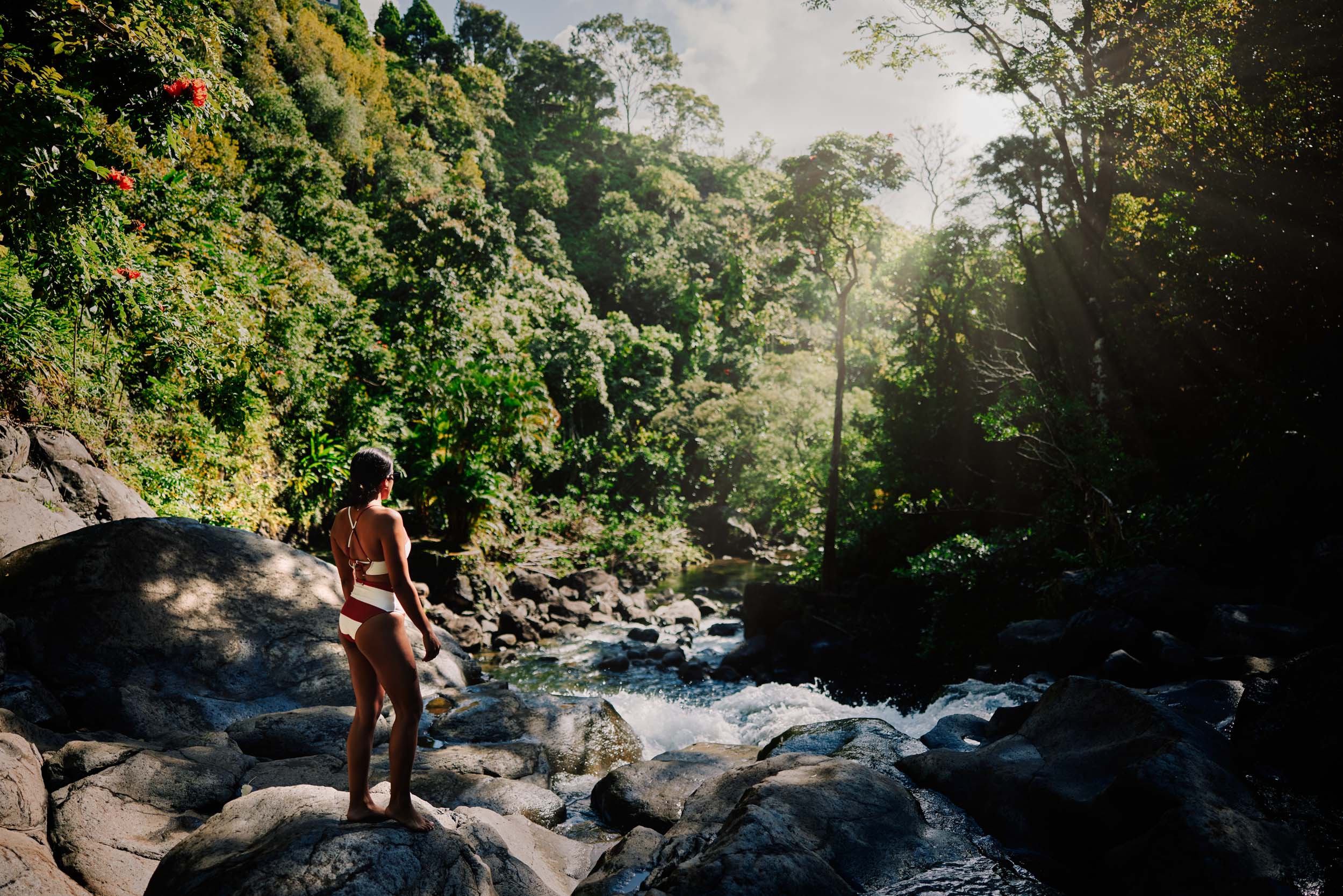 a woman on the rocks watching the river