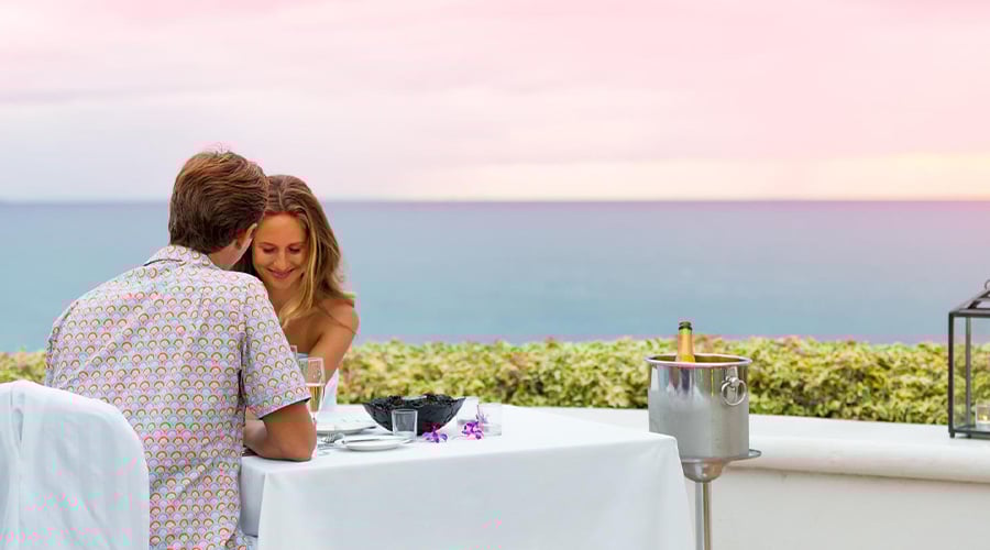 couple eating dinner at sunset