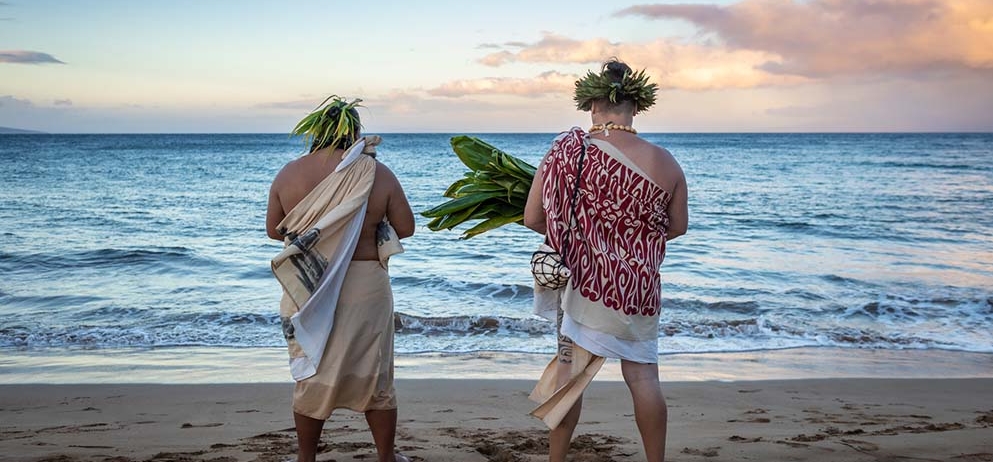 two men standing on the beach