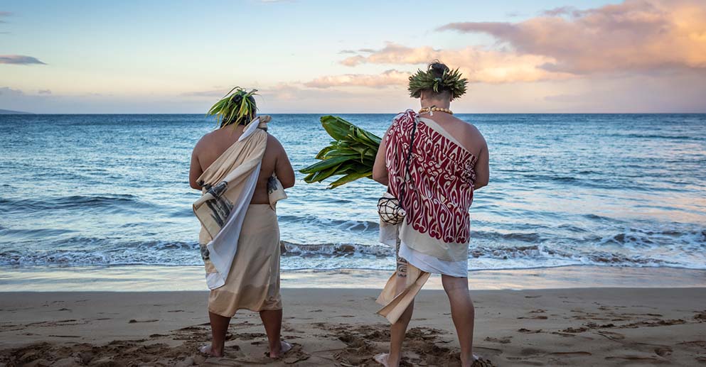 two men standing on the beach