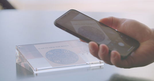 someone using their cellphone to scan qr code